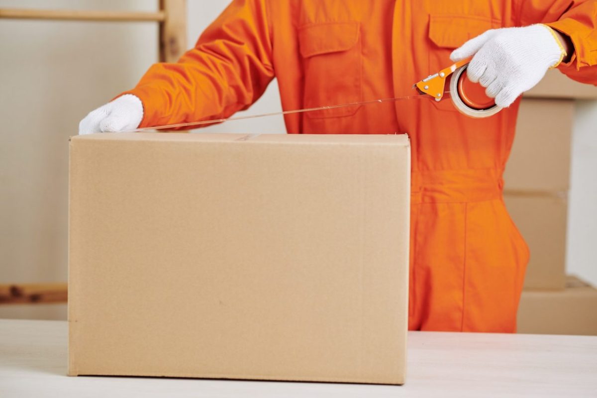 moving-service-worker-sealing-cardboard-box.jpg